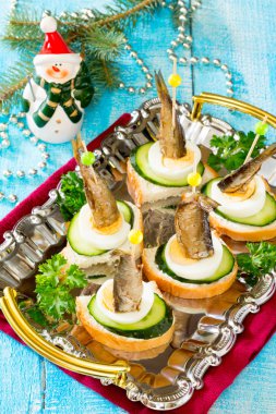 Canape with fresh cucumber sprats and New Year's Eve clipart