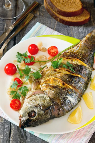 Baked fish with lemon on a dark wooden style — Stock Photo, Image