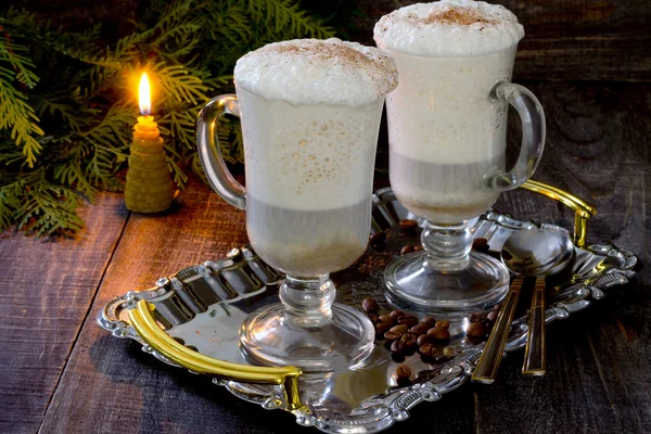 Cappuccino, egy fából készült asztal egy díszített karácsonyfa — Stock Fotó