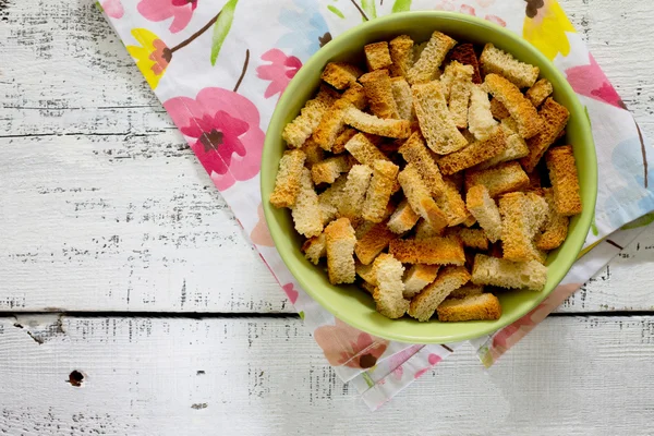 Crackers of white bread on a white wooden table — Stock Photo, Image