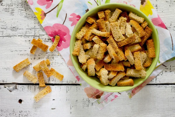 Crackers of white bread on a white wooden table — Stock Photo, Image