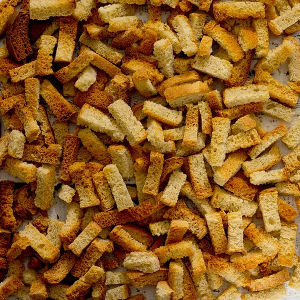 Crackers van wit brood op een witte houten tafel — Stockfoto
