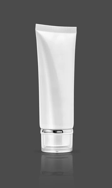 Blank packaging cosmetic tube isolated on gray background — Stock Photo, Image