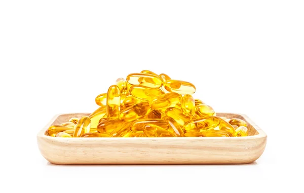 Fish oil capsules in wooden tray isolated on white background — Stock Photo, Image