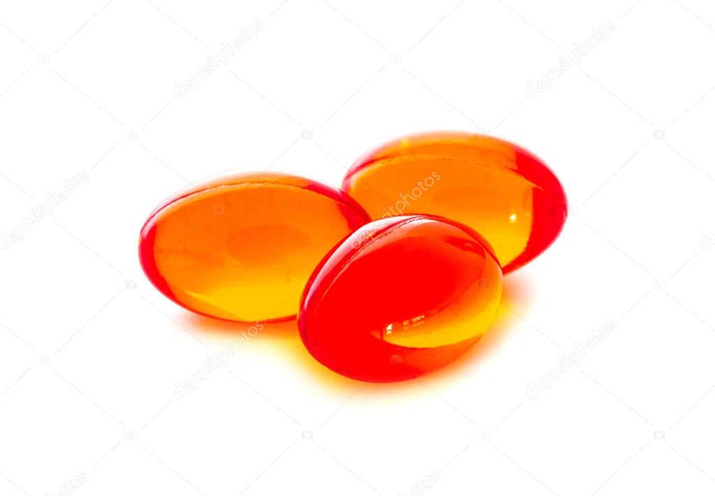 Red supplement capsules isolated on white background
