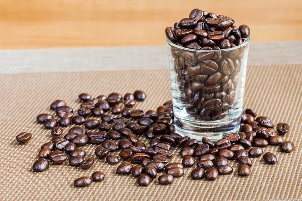 Kaffebönor i glas med varm ton — Stockfoto