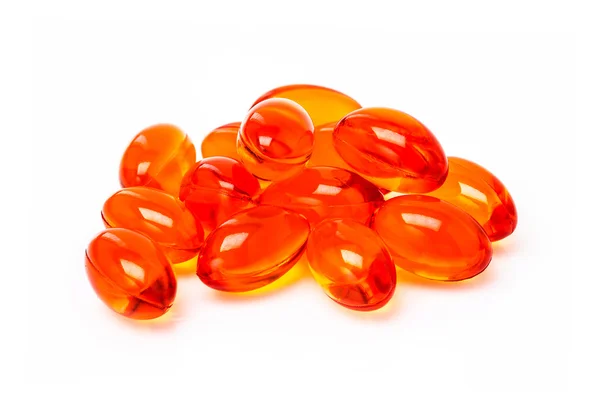 Red supplement capsules isolated on white background — Stock Photo, Image