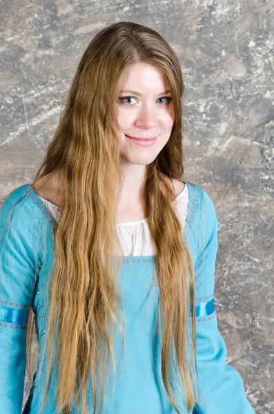 Portrait of the pretty young woman in blue dress — Stock Photo, Image