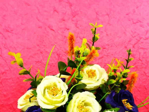 Bouquet de fleurs artificielles sur fond rose — Photo