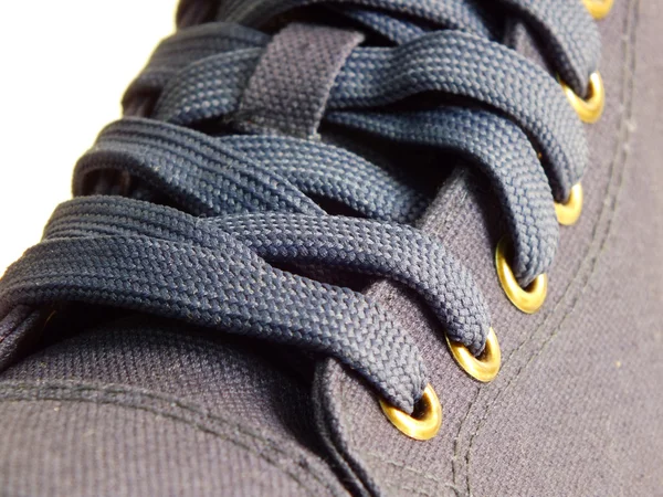 Detalj av ett par blå canvas sneakers — Stockfoto