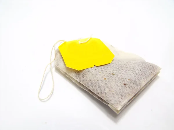 Tepåse med gul etikett isolerad på vit bakgrund — Stockfoto
