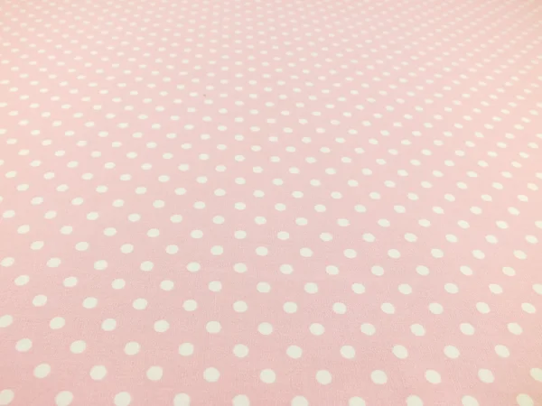 pink with white polka dot background