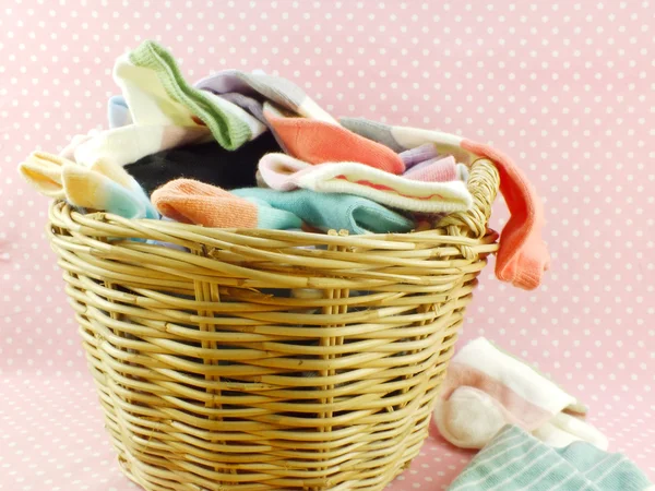 Multi colored socks and laundry basket — Stock Photo, Image