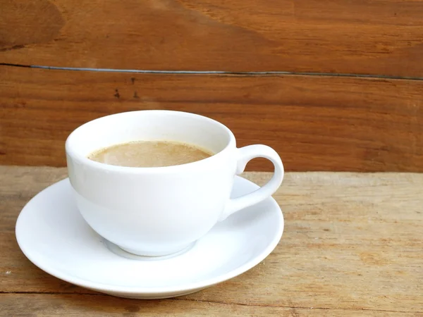 Cup of coffee on a wooden table background — Stock Photo, Image