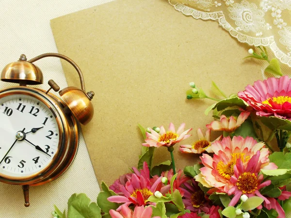 Spring time with alarm clock and artificial flowers bouquet background Royalty Free Stock Photos