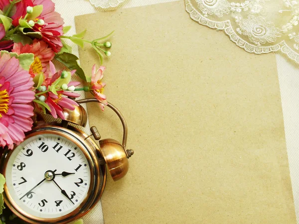 Spring time with alarm clock and artificial flowers bouquet background Royalty Free Stock Images