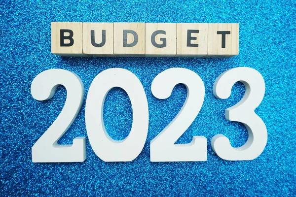 Budget 2023alphabet letters on blue glitter background