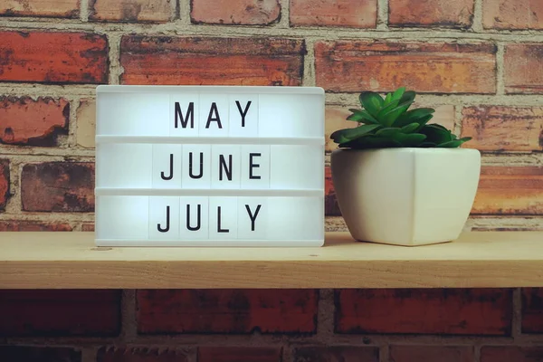 May June July Word Light Box Wooden Shelves Background — Stock Photo, Image
