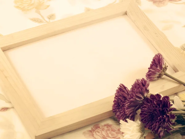 Blank wood frame and bouquet of chrysanthemums with vintage filters color — Stock Photo, Image