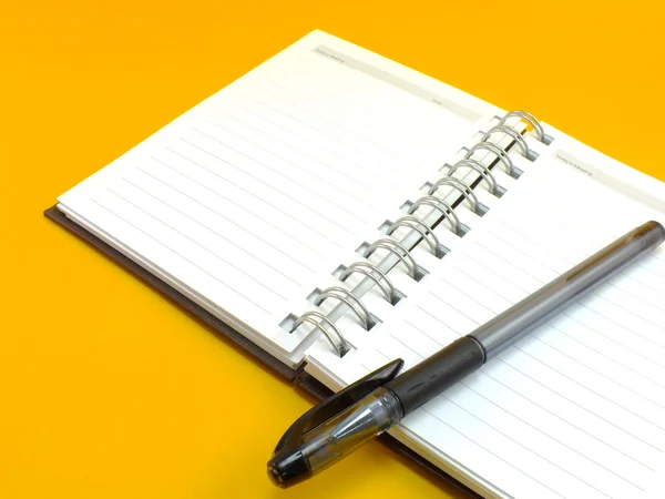 Notebook on yellow background — Stock Photo, Image