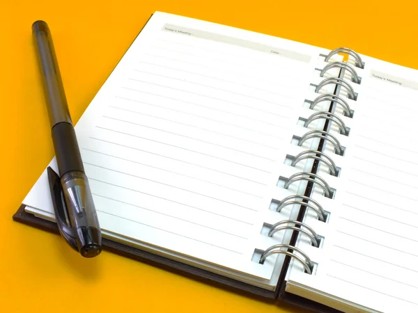 Notebook on yellow background — Stock Photo, Image