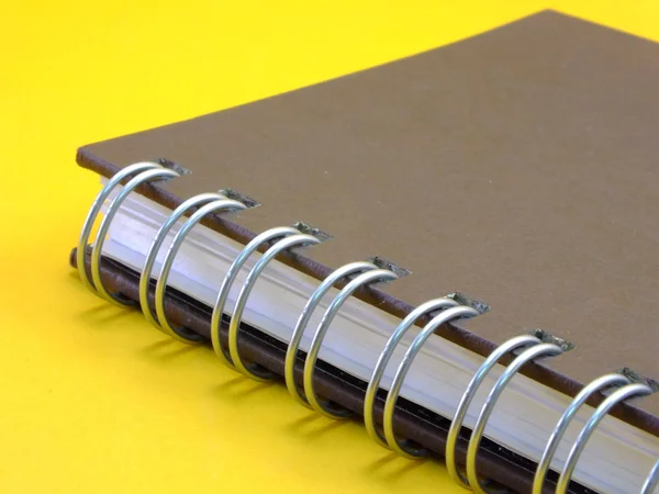 Notebook on yellow background — Stock Photo, Image