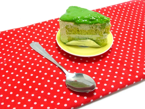 Green tea cake on red table cloth — Stock Photo, Image