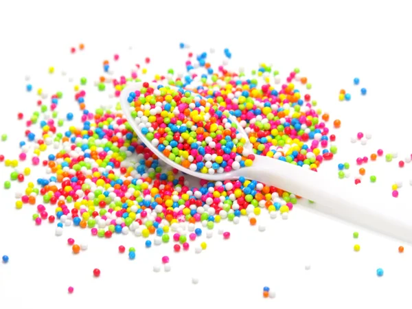 Colorful sugar pearls in white spoon — Stock Photo, Image