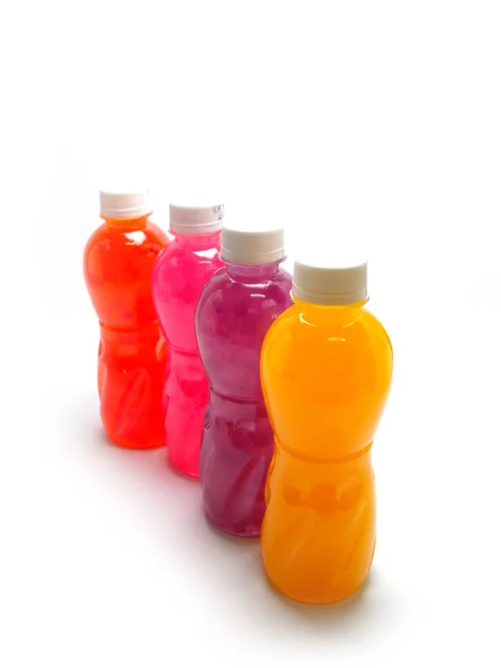 Botellas de jugo sobre un fondo blanco — Foto de Stock