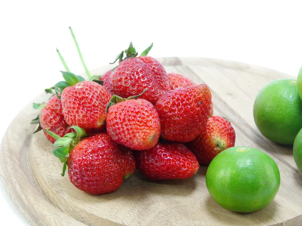 Strawberries with lime closeup over white background — Stock Photo, Image