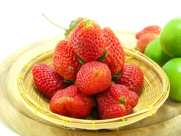 Strawberries with lime closeup over white background — Stock Photo, Image