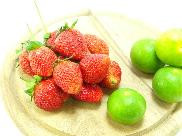 Strawberries with lime closeup over white background — Stock Photo, Image