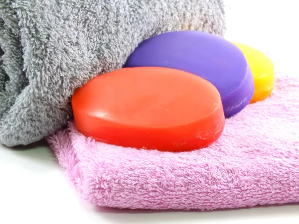 Towels with colorful pieces of soap — Stock Photo, Image