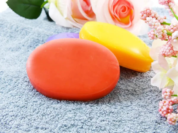 Towels with colorful pieces of soap — Stock Photo, Image