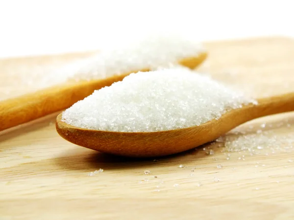 Sugar in a wooden spoon selective focus — Stock Photo, Image