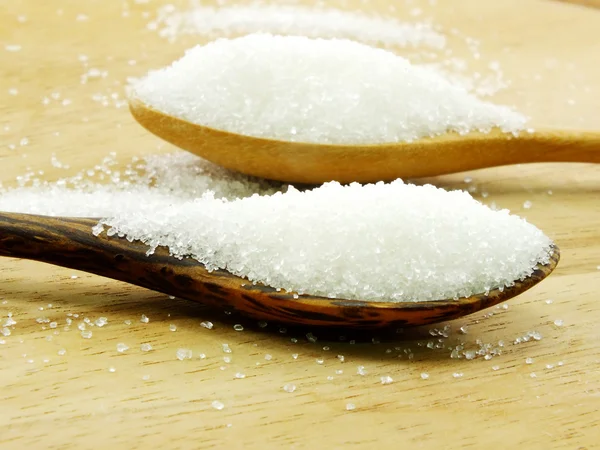 Sugar in a wooden spoon selective focus — Stock Photo, Image
