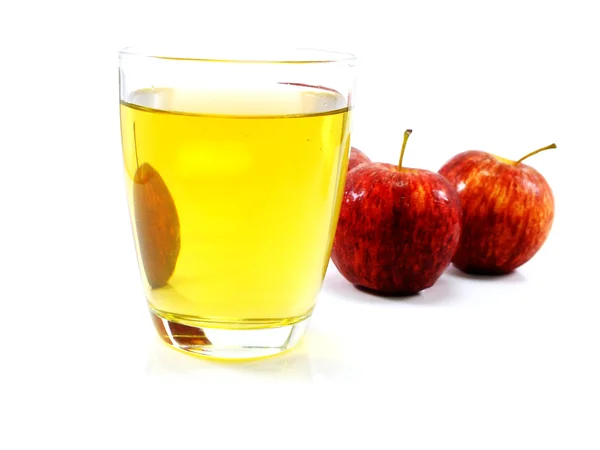 Red apples and glass of fresh apple juice over white background — Stok fotoğraf