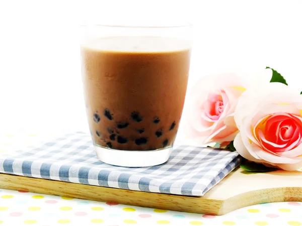 Chocolate milk with black jelly on tablecloth — Stock Photo, Image