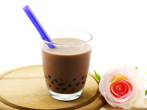 Chocolate milk with black jelly on tablecloth — Stock Photo, Image