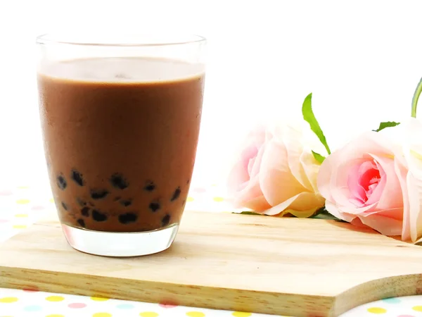 Chocolate milk with black jelly on tablecloth — Stock Photo, Image