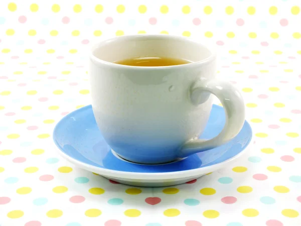 Tea in cup on sweet polka dot background — Stock Photo, Image