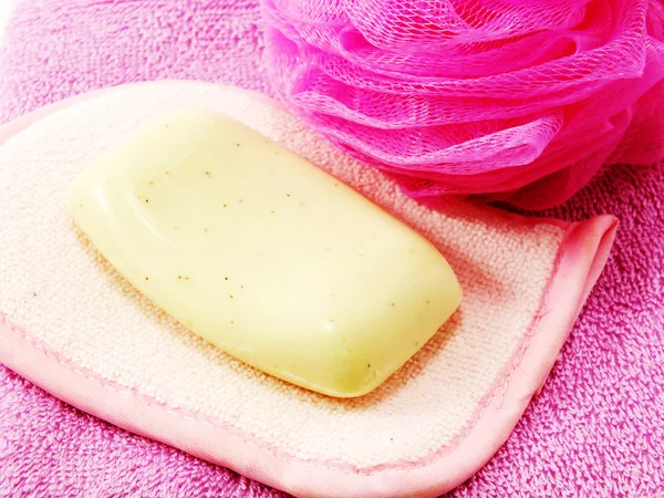 Pink towels and bath puff with white soap — Stock Photo, Image