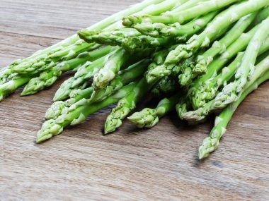 ahşap masa zemin üzerine yeşil ham kuşkonmaz