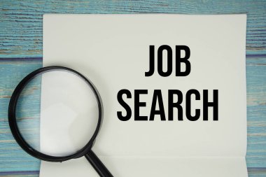 Not defterine yazılmış iş arama metni, büyüteç düzlüğü tahta zemin üzerinde yatıyordu