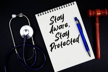 Siyah arka planda bir kalem, tokmak ve steteskop 