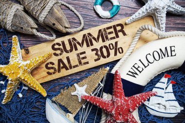 Yaz indirimi% 30 indirimli tahta tabela ile süslenmiş ahşap arka planda deniz piyadesi.