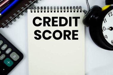 Not defterine hesap makinesi ve alarm saati ile yazılmış kredi notu metni