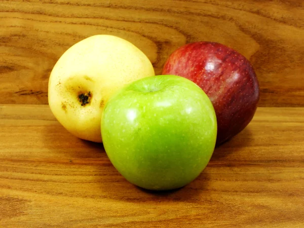 Manzana verde pera china amarilla y manzana roja sobre fondo de madera — Foto de Stock