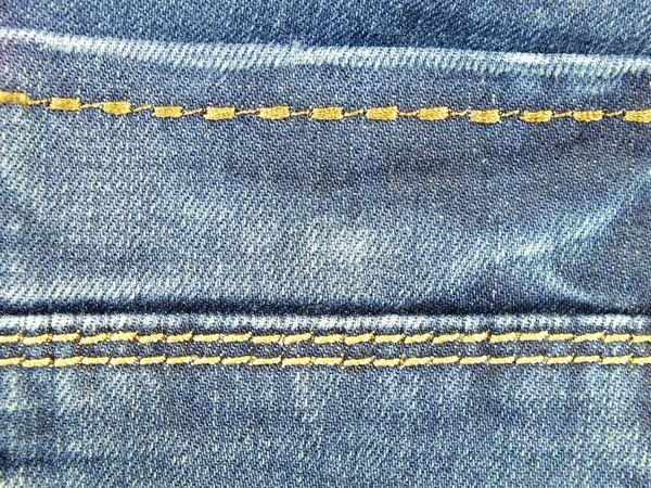 Textura jeans azul com fundo costuras — Fotografia de Stock
