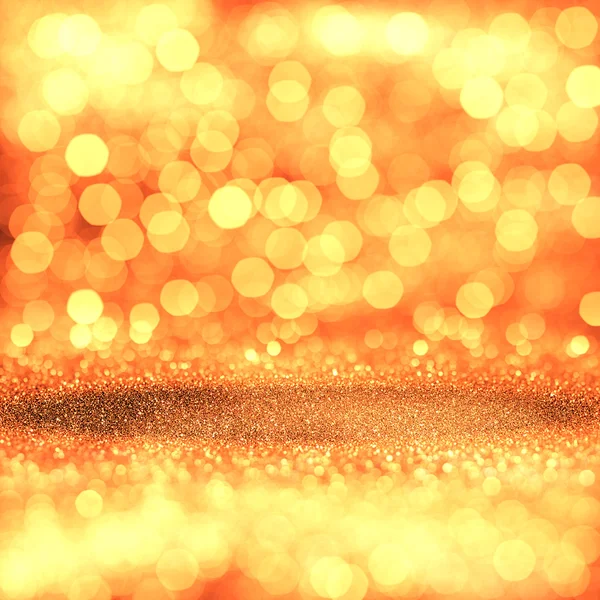 Odaklanamayan ışıklarla altın renkli ışıltı arka planı — Stok fotoğraf